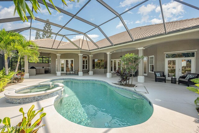 view of swimming pool featuring a patio area, an in ground hot tub, glass enclosure, and outdoor lounge area