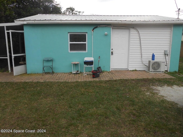 back of property featuring ac unit, a patio area, and a lawn