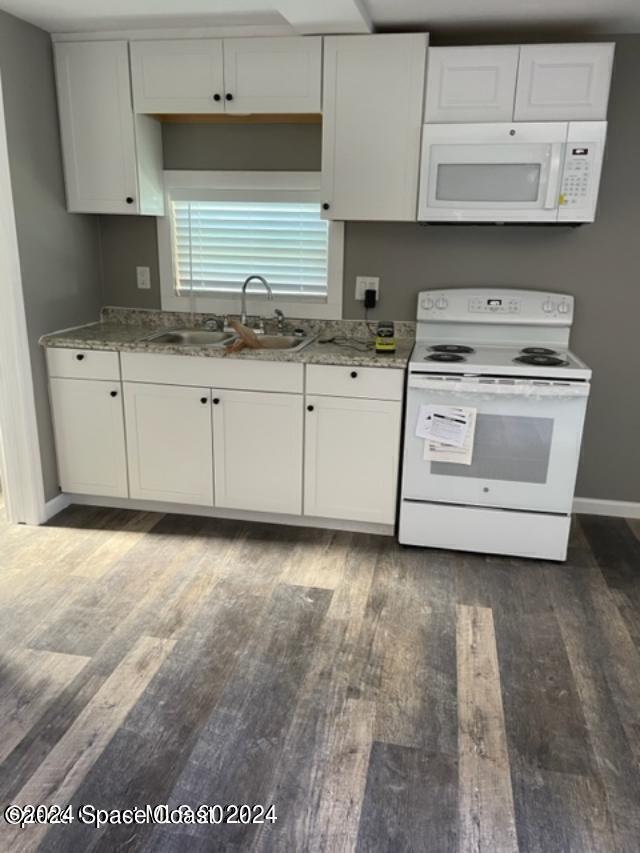 kitchen featuring white cabinets and white appliances