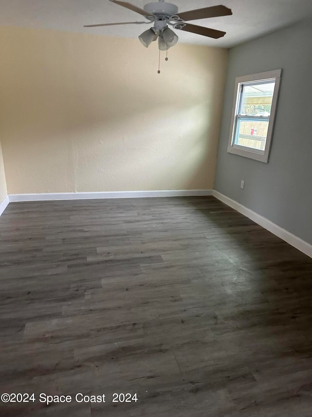 empty room featuring dark hardwood / wood-style flooring and ceiling fan