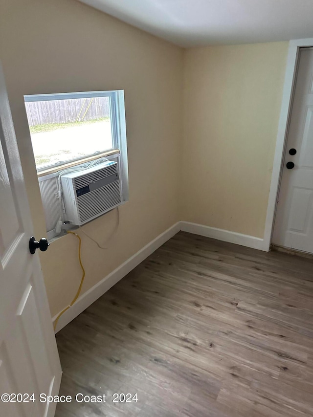 empty room with light hardwood / wood-style flooring and cooling unit