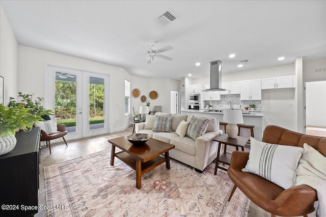 living room featuring french doors, sink, and ceiling fan