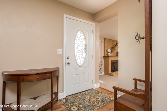 entrance foyer with a fireplace and hardwood / wood-style floors