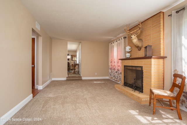 unfurnished living room featuring carpet flooring and a fireplace