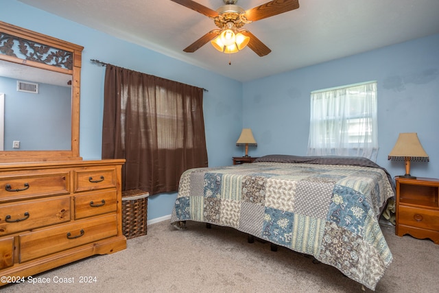 bedroom with light colored carpet and ceiling fan