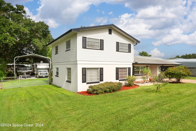 view of front of property featuring a front yard and a carport