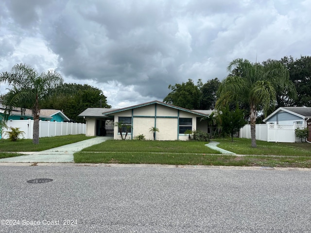 ranch-style house with a front lawn