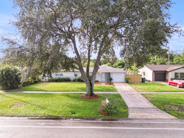 view of front of house with a garage and a front lawn