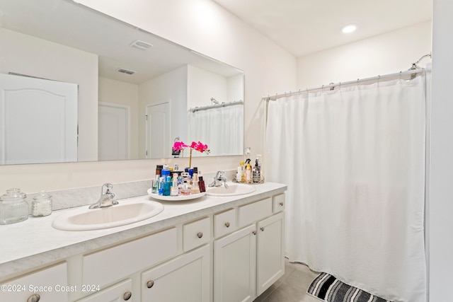 bathroom featuring tile patterned flooring and vanity