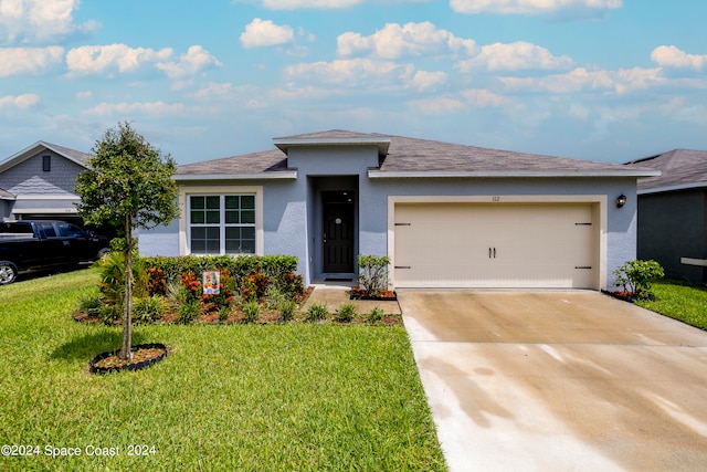 view of front facade with a garage and a front lawn