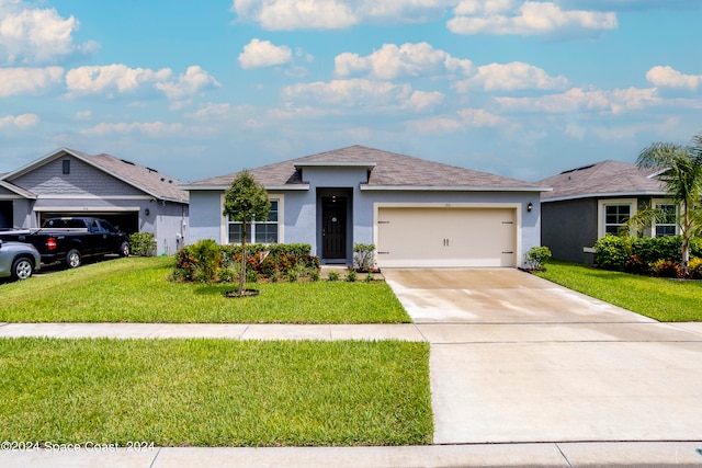 ranch-style house with a garage and a front lawn