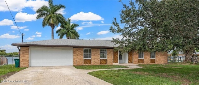 view of front of property featuring a front yard and a garage