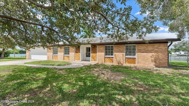 single story home with a garage and a front yard