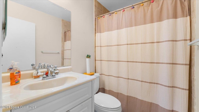 bathroom featuring walk in shower, vanity, and toilet