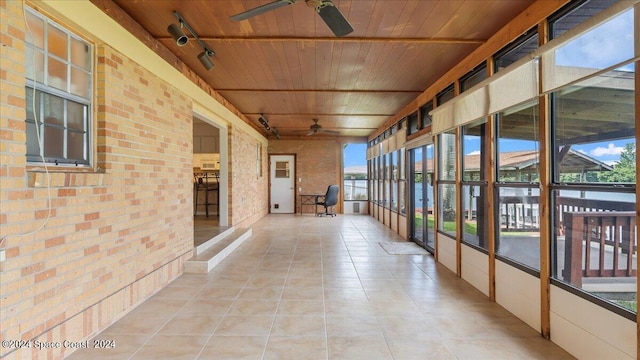 interior space with wooden ceiling, rail lighting, and ceiling fan