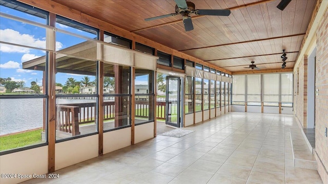 unfurnished sunroom featuring wood ceiling, ceiling fan, and track lighting