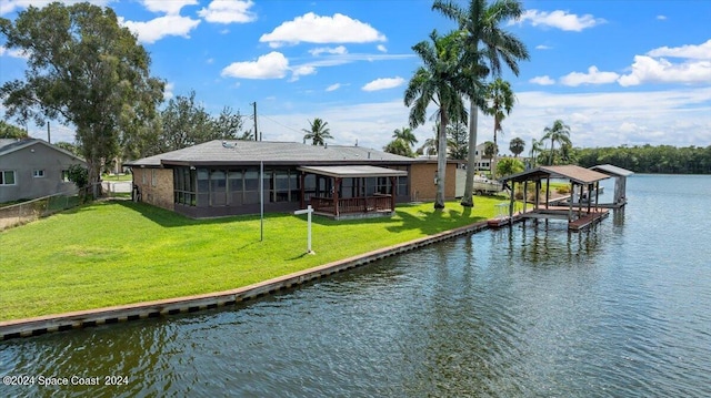 dock area with a yard and a water view