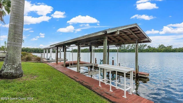 dock area featuring a lawn and a water view