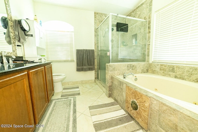 full bathroom with tile patterned floors, separate shower and tub, toilet, and vanity