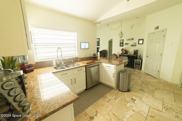 kitchen featuring pendant lighting, stainless steel dishwasher, kitchen peninsula, sink, and white cabinets