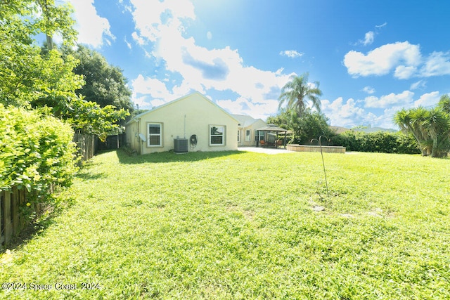 view of yard featuring central AC unit and a patio area