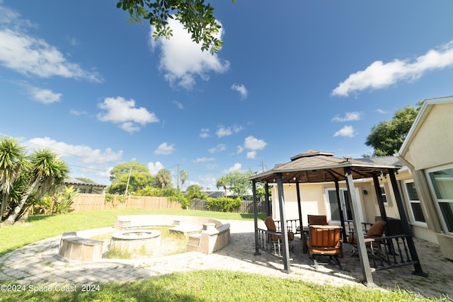 view of yard with an outdoor fire pit, a gazebo, and a patio area