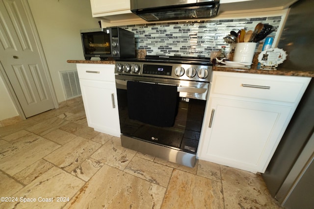 kitchen featuring white cabinetry, exhaust hood, decorative backsplash, and stainless steel range oven