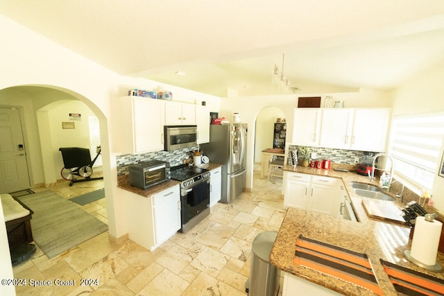 kitchen featuring white cabinetry, backsplash, stainless steel appliances, and sink