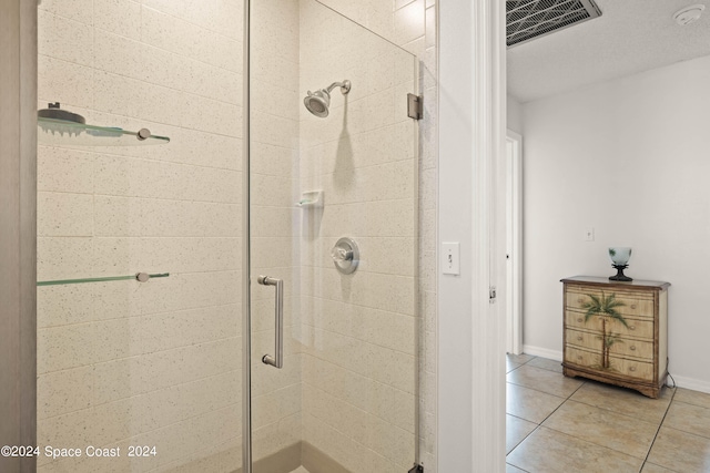 bathroom with walk in shower and tile patterned floors