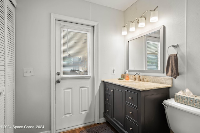 bathroom featuring hardwood / wood-style floors, vanity, and toilet