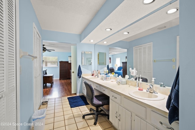 bathroom featuring tile patterned flooring, ceiling fan, vanity, and a textured ceiling