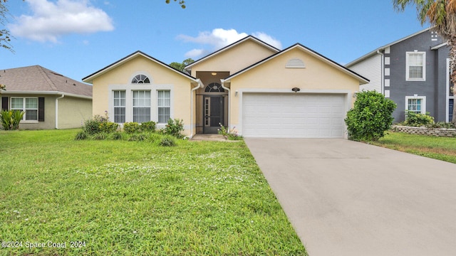 view of front of property featuring a garage and a front yard