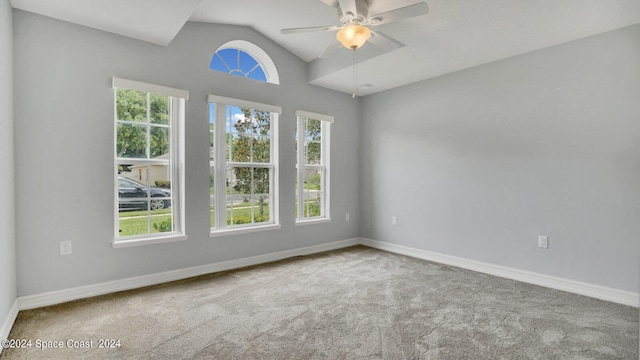 carpeted spare room with lofted ceiling and ceiling fan