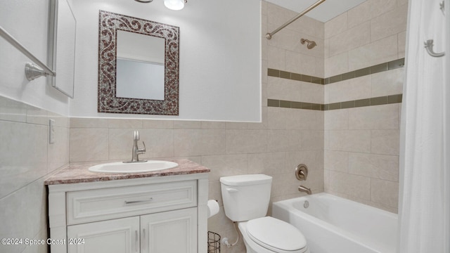 full bathroom with vanity, tile walls, toilet, decorative backsplash, and shower / bath combo