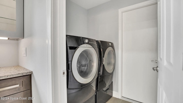 washroom featuring separate washer and dryer and light tile patterned floors