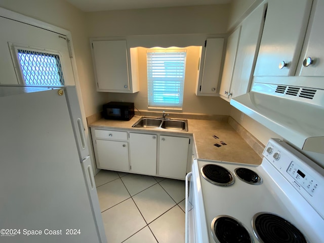 kitchen featuring light tile patterned flooring, white appliances, white cabinetry, and sink