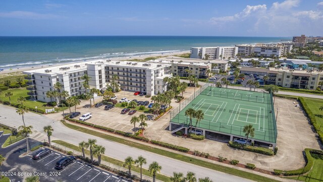 drone / aerial view featuring a water view and a beach view