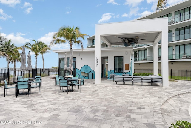 view of patio featuring ceiling fan, an outdoor living space, and a balcony