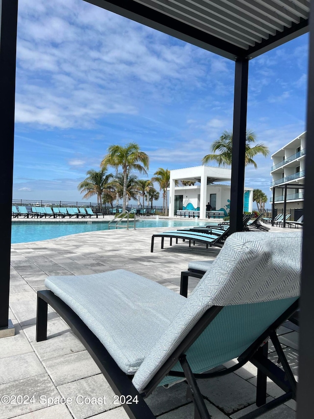 exterior space with a community pool and a water view