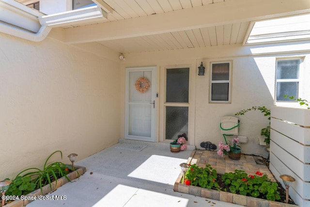 view of exterior entry featuring a patio area