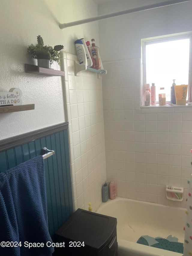 bathroom with shower / bath combo with shower curtain