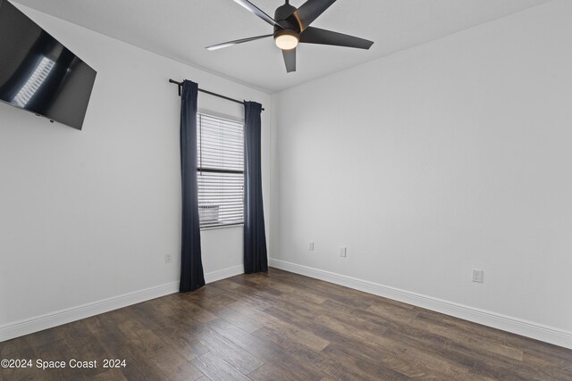 spare room with ceiling fan and dark hardwood / wood-style flooring