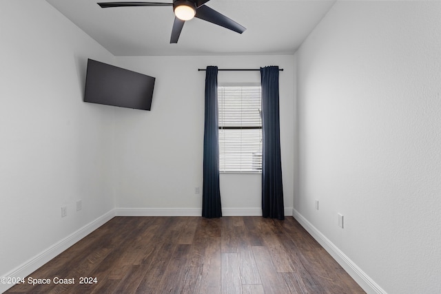 spare room featuring ceiling fan and dark hardwood / wood-style flooring