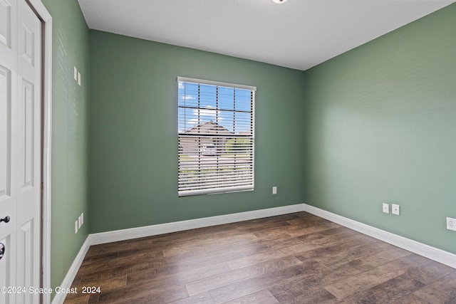 unfurnished bedroom with wood-type flooring and a closet