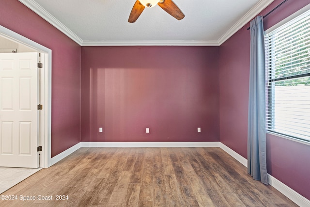 empty room featuring crown molding, dark wood-type flooring, ceiling fan, and a textured ceiling