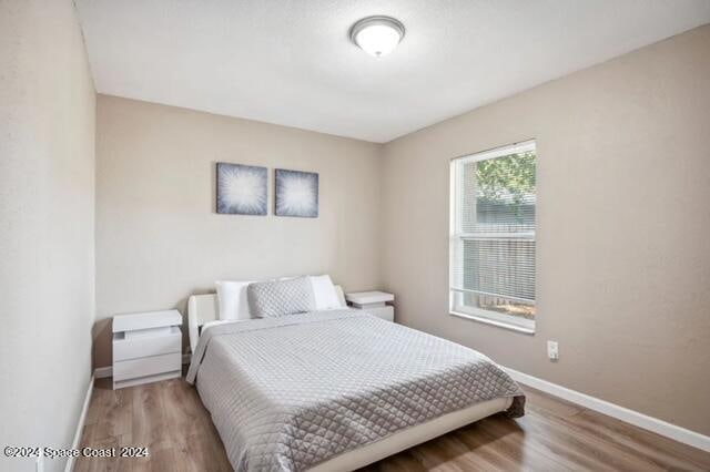 bedroom with wood-type flooring