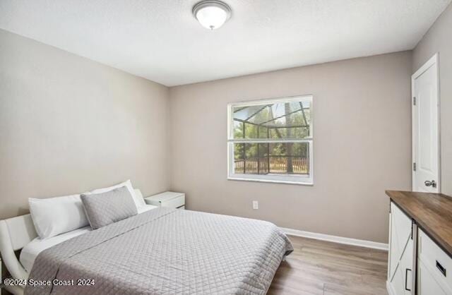 bedroom with hardwood / wood-style flooring