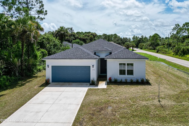 view of front of property with a front lawn and a garage