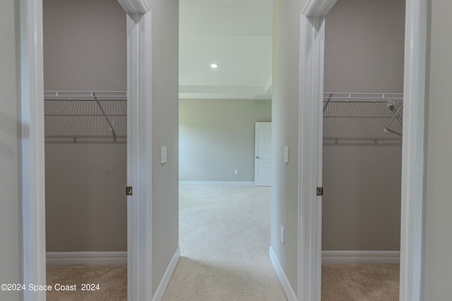 corridor featuring light colored carpet