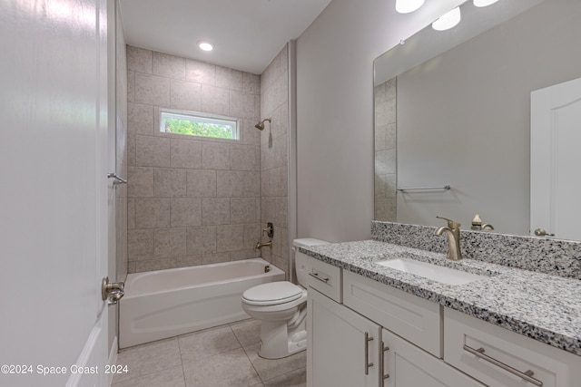 full bathroom with tiled shower / bath, vanity, toilet, and tile patterned flooring